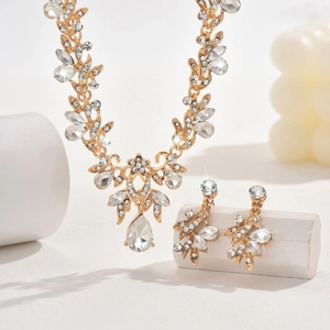 Golden bridal jewelry set with crystal leaf vines and teardrop pendants for weddings