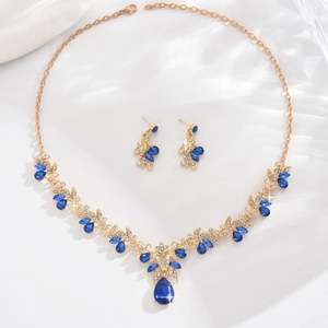 Detail of bridal jewelry set with blue teardrop stones and marquise-cut crystals
