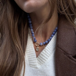 Sky blue beaded necklace with gold ring clasp and clear oval crystal pendant for women