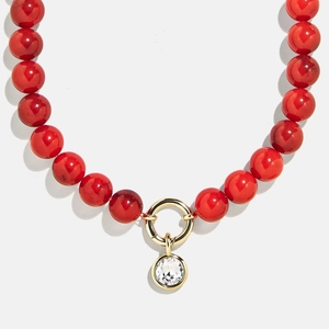 Luxurious red beaded necklace with gold stainless steel zircon pendant on white background
