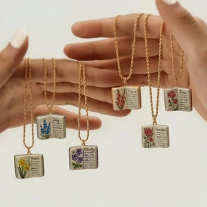 Dettaglio della collana medaglione a libro vintage con fiori e catena dorata