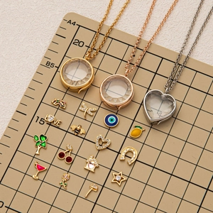 Locket necklace set with floating charms in gold, rose gold and silver finishes