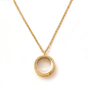 Minimalist gold necklace with a round faceted clear crystal pendant on a cable chain