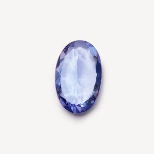 Macro shot of high-clarity oval cut lavender gemstone with symmetrical light reflections