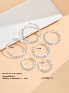 Three pairs of silver hoop earrings with rhinestones in 4cm, 5cm, and 6cm sizes