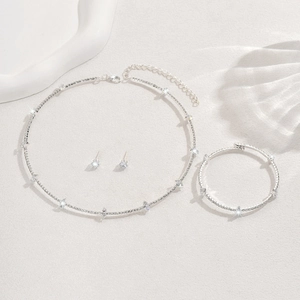 Macro detail of elegant silver bridal jewelry set with sparkling marquise cut crystals