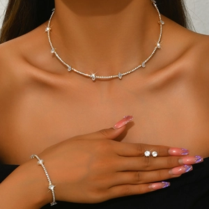 Detail of elegant gold-tone marquise crystal jewelry set including necklace and earrings