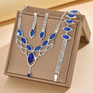 Macro view of crystal mesh necklace set with teardrop blue stones on jewelry box