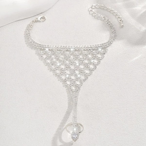 Detail of silver hand harness with mesh rhinestones and a water drop crystal ring