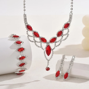 Detailed view of silver jewelry set with red marquise crystals and sparkling rhinestones