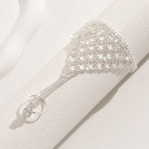 Sparkling silver mesh hand chain with rhinestone finger ring bracelet on display stand