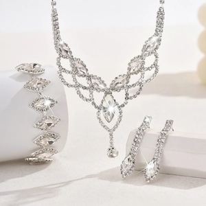 Detail of elegant bridal jewelry set with sparkling teardrop crystals on white pedestals