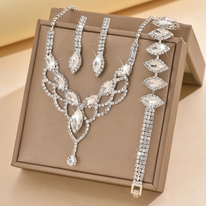 Close-up of sparkling silver bridal jewelry set with water drop rhinestones in a brown box
