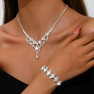 Detail of bridal jewelry set with sparkling teardrop crystals on mesh silver necklace