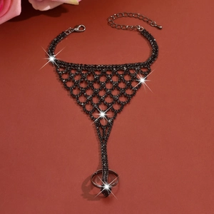 Detailed view of the black rhinestone mesh hand harness with adjustable lobster clasp