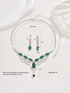 Detailed view of teardrop emerald necklace and earrings set with crystal mesh drapes