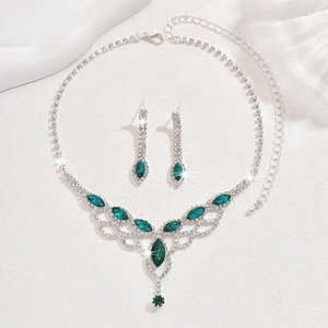 Detailed close-up of emerald green jewelry set with water drop rhinestones and silver base