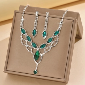 Detail of bridal jewelry set with green marquise stones and sparkling crystals in a gift box