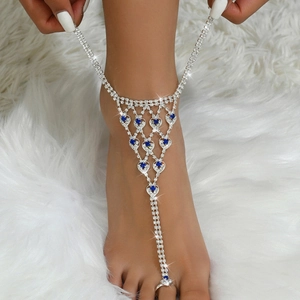 Detail of silver toe ring anklet featuring blue crystal hearts and sparkling rhinestones