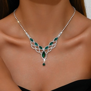 Detailed view of teardrop mesh necklace with green marquise stones and white rhinestones