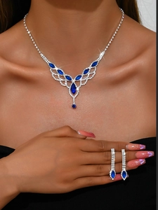 Detail of elegant bridal necklace set with deep blue gems and sparkling diamonds