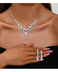 Close-up of sparkling bridal V-shaped rhinestone necklace and dangling fringe earrings