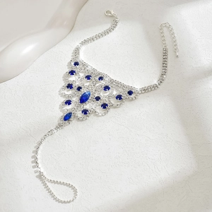Macro detail of silver hand harness featuring blue rhinestones and vintage hollow design