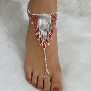 Detail of silver rhinestone anklet with toe ring featuring vibrant red teardrop crystals