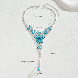 Detailed view of flower slave bracelet with blue crystals and silver-tone rhinestones