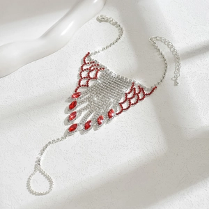 Detailed macro view of silver ring bracelet featuring red rhinestones and fringe
