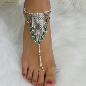 Detail of silver rhinestone anklet with emerald-cut gems and multi-layer tassels