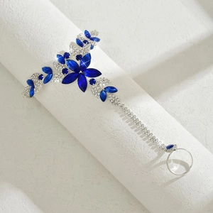 Detailed macro view of bohemian silver slave bracelet with blue marquise crystals