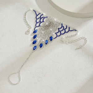 Detail of silver chain bracelet with blue rhinestones and intricate bohemian mesh design