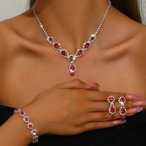Elegant silver bridal jewelry set with red gemstones and crystals on a female model