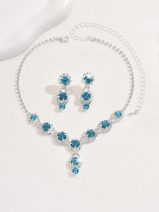 Detail of silver bridal necklace and earrings set featuring navy blue crystal accents