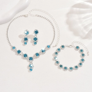 Detailed macro view of bridal jewelry set with blue gems and sparkling rhinestones