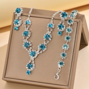 Detail of silver bridal jewelry set with sapphire blue rhinestones and snowflake design