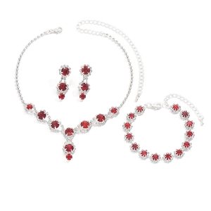 Women's bridal jewelry set featuring red rhinestone necklace, bracelet and earrings