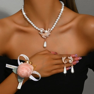 Close-up of pearl necklace set with rose gold phoenix pendant and water drop pearl