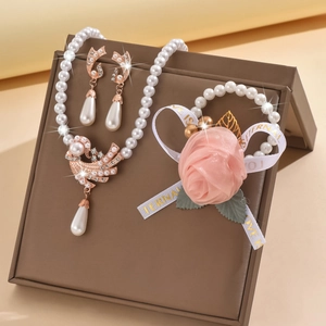 Elegant bridal jewelry set with pearl necklace, bird pendant, earrings, and floral bracelet