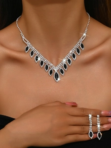 Detail view of a V-shaped bridal jewelry set with black stones and sparkling rhinestones
