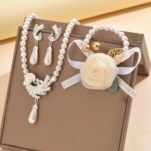 Elegant pearl jewelry set with swan pendant necklace, floral bracelet and crystal earrings