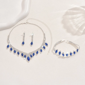Macro detail of bridal jewelry set with blue marquise gems and sparkling rhinestones
