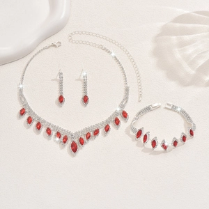Macro view of silver bridal jewelry set with sparkling red rhinestones and fringe details