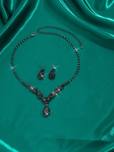 Macro detail of Halloween bridal jewelry set with black water drop gems and necklace