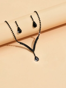 Detail shot of black rhinestone bridal necklace and teardrop earrings on display