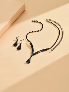 Detail view of Halloween bridal jewelry set with black teardrop gemstones and metal chains