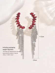 Detail showing 11.5cm long crystal fringe earrings with elegant red gemstones and silver tassels
