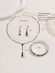 Detailed view of silver jewelry set with black rhinestones featuring size specifications