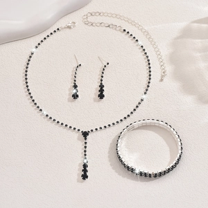 Close-up of four-piece silver jewelry set with double-row black rhinestones for weddings